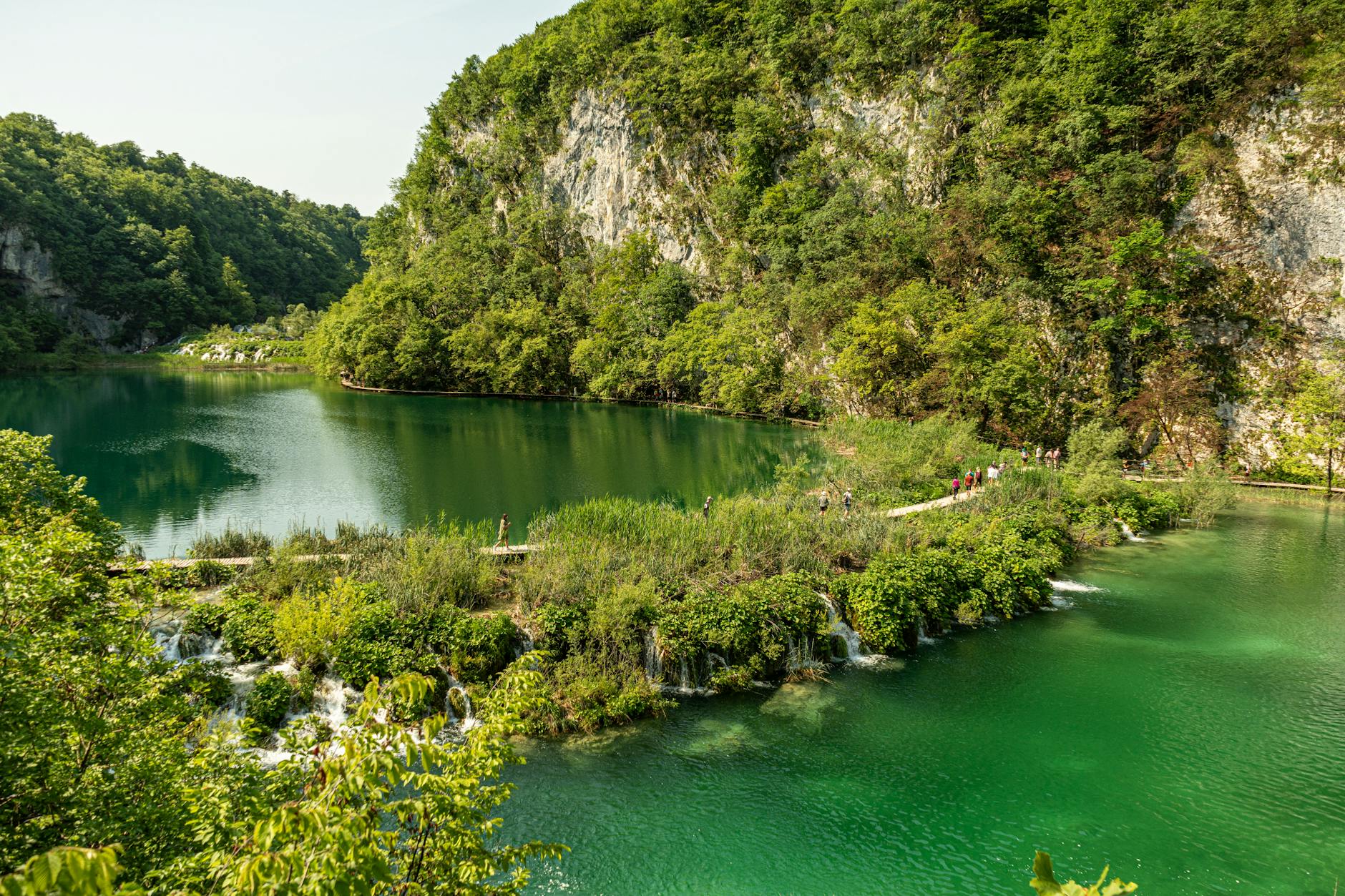 Wodospad wśród zieleni w parku krajobrazowym latem
